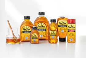 Sue Bee Pure Premium Honey being poured over yogurt shows versatile natural sweetener.
