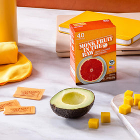 Sugar In The Raw monk fruit packets in a glass with ice demonstrate zero-calorie flavor for cold drinks.