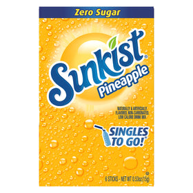 Sunkist Singles-To-Go pineapple box in a car cup holder for on-the-go refreshment.