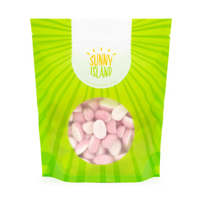 Sunny Island party decor uses pink strawberry gummies to enhance dessert tables.