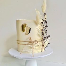 SUVO gold baby feet toppers displayed on cakes and cupcakes for celebrations
