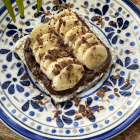 Suzie’s Brown Rice Cake Thins topped with cheese, ready to snack.