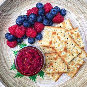 Suzie’s Organic Saltines rosemary infusion with visible rosemary specks on cracker surface.