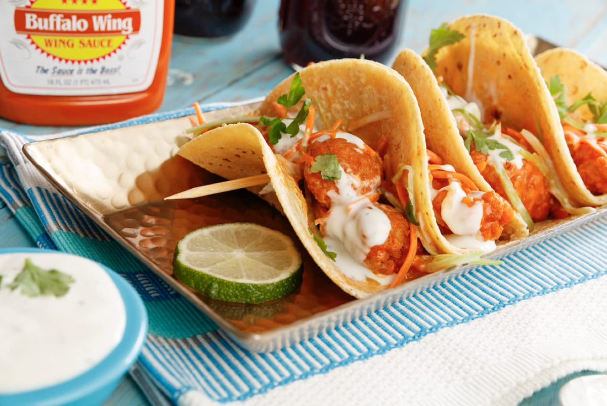 Sweet Baby Ray's Buffalo Wing Sauce on a pile of wings for a bold finish.
