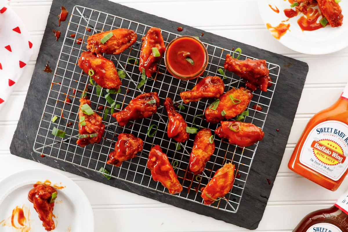 Sweet Baby Ray's Buffalo Wing Sauce bottle beside wings signals quick wings upgrade.