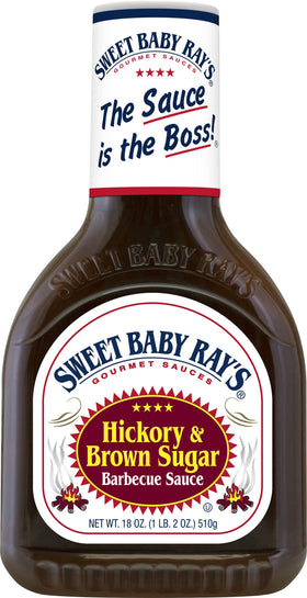 Sweet Baby Ray's Honey BBQ sauce pouring over grilled chicken with a glossy glaze.