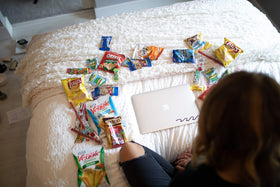 Birthday gift-ready snack basket with chips, cookies, and bars