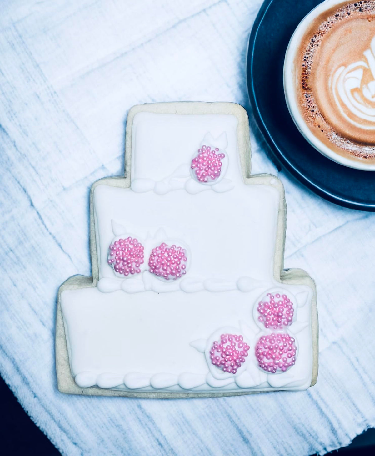Sweet Eva’s pink pearl nonpareils top donuts for a pink glow
