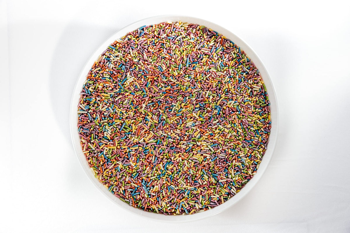 Sweet Eva’s Sprinkles brighten cupcakes with a shimmering rainbow finish.
