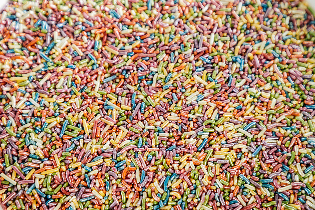 Sweet Eva’s Rainbow Sprinkles on cake layers add elegant color and sparkle.
