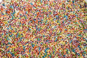 Sweet Eva’s Rainbow Sprinkles on cake layers add elegant color and sparkle.