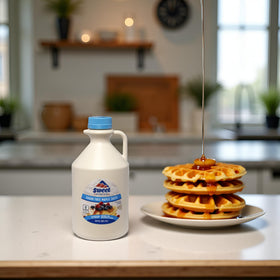 Sweet Mountain sugar-free maple syrup in a dessert dish, versatile flavoring for baking or desserts.