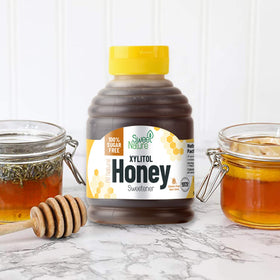Sweet Nature Birch Xylitol Honey jar label in a pantry scene highlighting non GMO features
