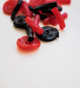 SweetGourmet Italian Strawberry Licorice Wheels stacked, showcasing wheel shape and bulk quantity.