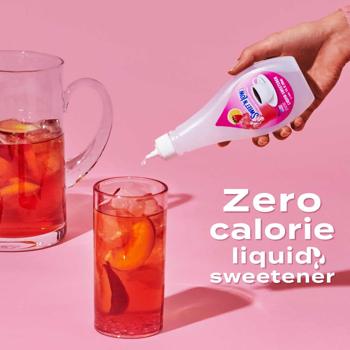 Pouring Sweet'N Low strawberry liquid for quick flavor boost in cold drinks.