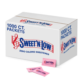 Sweet'N Low zero-calorie packets beside a coffee cup for zero calorie sweetness.