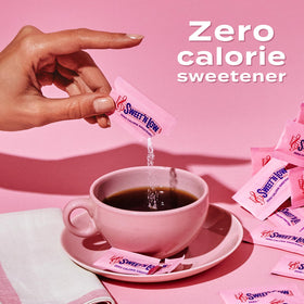 Sweet'N Low packets near a glass of iced tea for flavor without sugar.