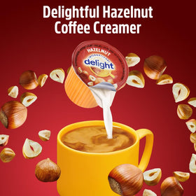 Close-up of SWEETSIDE Delight hazelnut creamer cup dissolving smoothly in coffee.