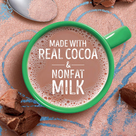 Pouring Swiss Miss milk chocolate powder into a mug for a creamy moment