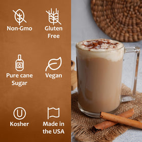 SYRUVIA Cinnamon Dolce Syrup bottle on a kitchen display with ingredients nearby.