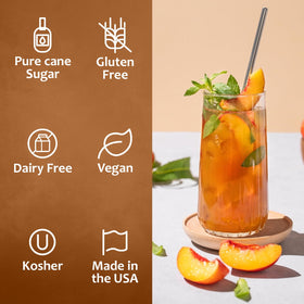 Pouring SYRUVIA Peach Syrup into a glass with ice highlights fruity aroma and sweetness.