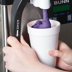 TableTop King grape slushy snow cone served at festival.
