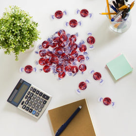 Close-up of Taboom cinnamon hard candy discs with fiery red color and bold aroma.