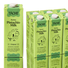 Táche Pistachio Milk being poured into coffee for a silky latte.