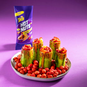 Takis Fuego Hot Nuts on shelf display, party-ready snack choice.