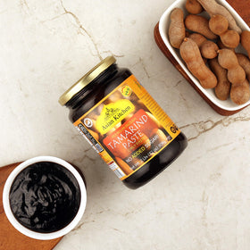 tamarind paste imli pouring into bowl for chutneys and sauces