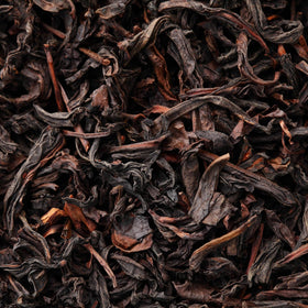 Tapal Danedar tea leaves close-up with steaming cup and aroma