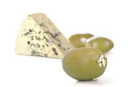 Closeup of Tassos hand-stuffed colossal olive showing creamy cheese filling.