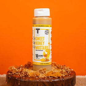 Taste Flavor Co. Sweet Honey Mustard marinade bottle enhances quick flavor during cooking.