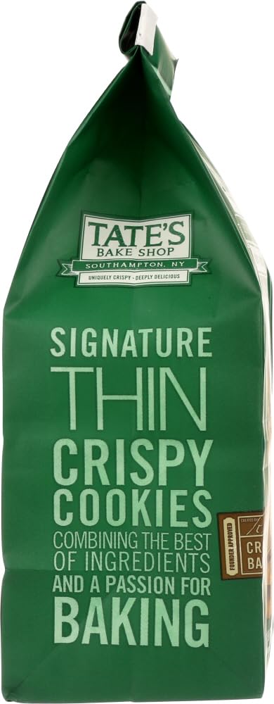 Closeup of Tate's Chocolate Chip Walnut cookie highlighting melted chips and nutty texture.