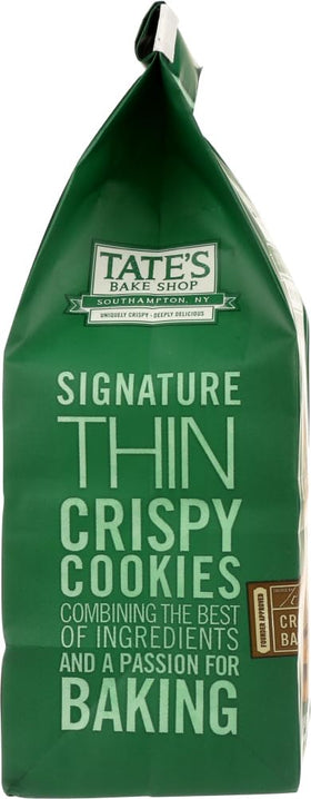 Closeup of Tate's Chocolate Chip Walnut cookie highlighting melted chips and nutty texture.