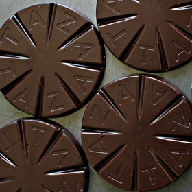 Taza Mexicano Disc 85% sits ready for hot or iced chocolate.