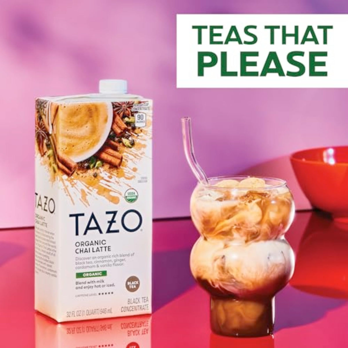 Pouring TAZO Organic Chai Latte concentrate into milk for a creamy latte.