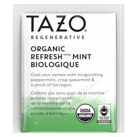 Tea bag steeping in hot water to unleash mint aroma in a cup of Tazo Refresh Mint.