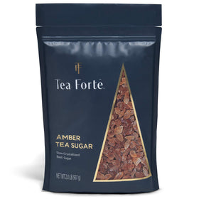 Tea Forte amber hue rock sugar crystals being poured into a cup for quick sweetness