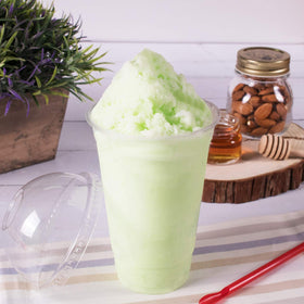 Tea Zone Honeydew Powder smoothie glass highlights vibrant color and creamy texture.