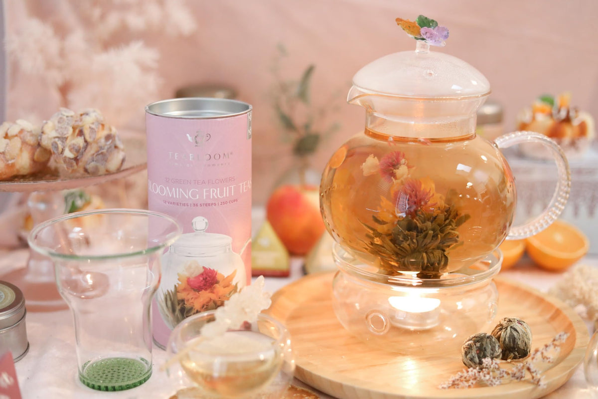 Teabloom strawberry bloom tea in clear glass showing blossoming floral tea ball