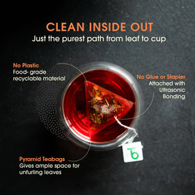 Dried hibiscus flowers with tea bags, hinting at a fruity aroma and color.