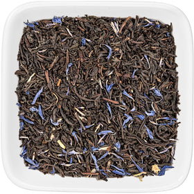 Warm cup of Cream Earl Grey Moonlight beside a vanilla bean