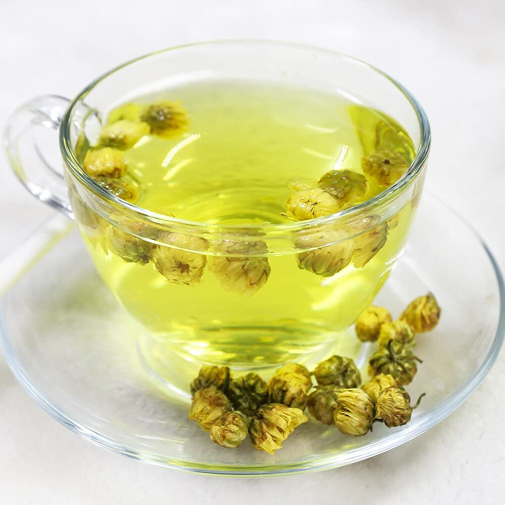 Close view of TEARELAE chrysanthemum tea leaves in a pale, fragrant brew