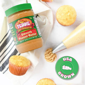 Teddie Smooth peanut butter jar with spoon for easy scooping.