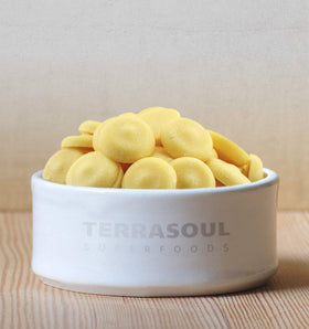 Terrasoul cacao butter wafers melting in a warm pan, ready for creamy desserts.