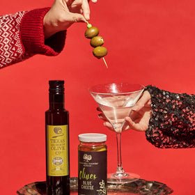 Texas Hill Country Olive Co. dirty martini ready to pour depicted in a stylish glass.