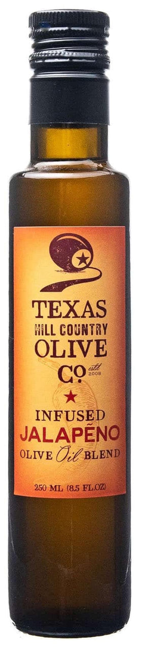 Texas Hill Country Olive Co Jalapeño Infused Olive Oil bottle pour for spicy, balanced flavor.