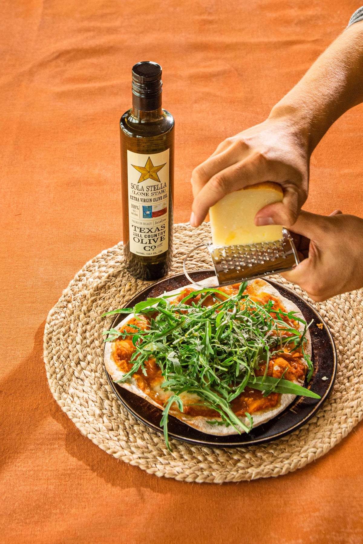 Sola Stella in a kitchen scene highlighting versatile EVOO for cooking and finishing.
