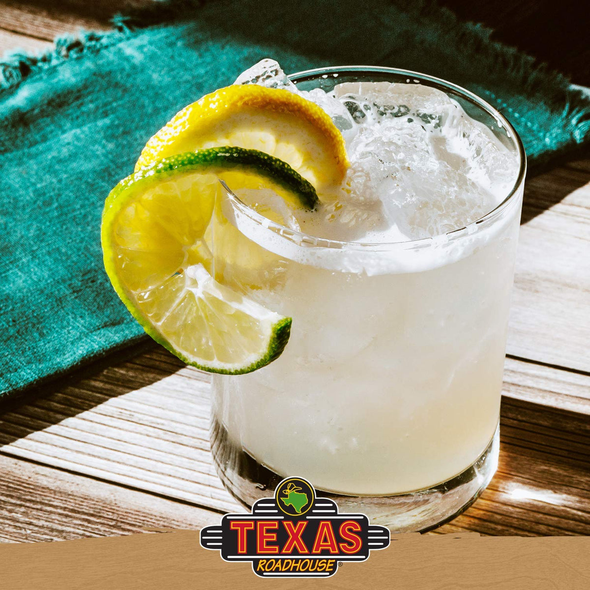 Texas Roadhouse margarita mix pour bottle demonstrates quick cocktail prep.
